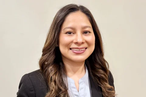 Nursing alumna Jeanette Ruiz wearing a black jacket and blue shirt. 