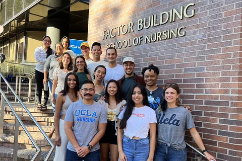 Nursing students standing in front of the UCLA Nursing main entrance