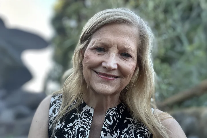 Nursing alumna Janet Boydstu wearing a black and white shirt.