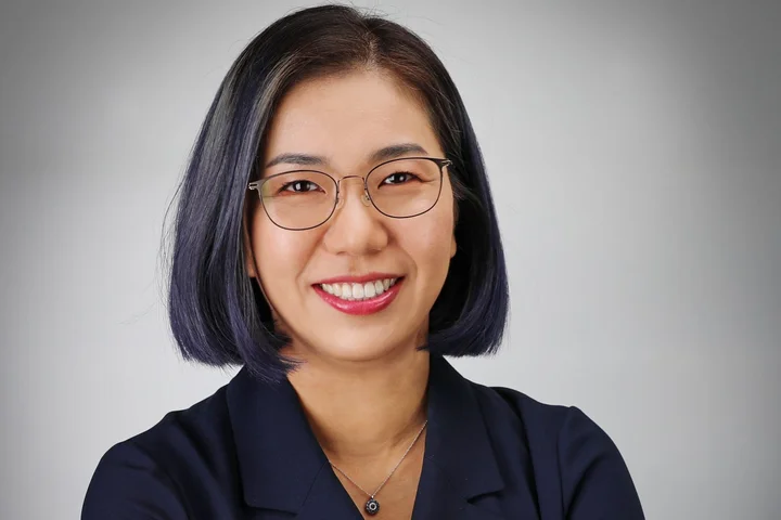 Dr. Sarah Ko headshot, wearing glasses and dark collared shirt.