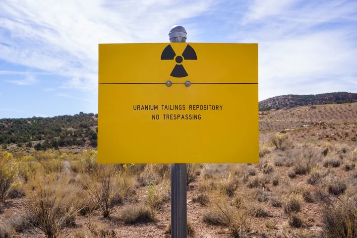 A yellow no trespassing sign near a uranium repository
