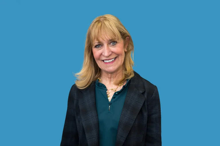 Barbara Bates-Jensen in dark grey jacket and green shirt. 