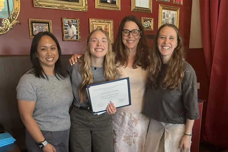 Lexi Phillips holding her scholarship award with 3 nurses from the LA NAPNAP Chapter