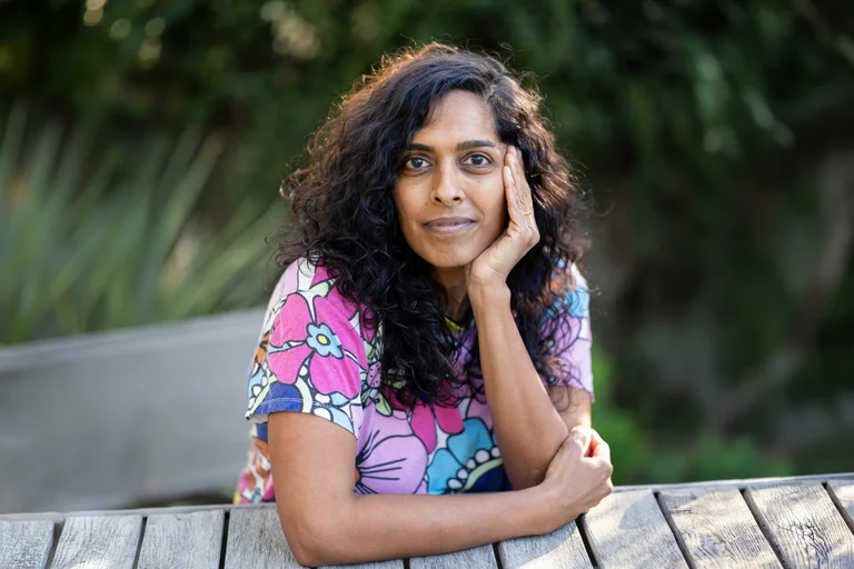 UCLA nursing student Priya Swaminathan sitting at a park bench.