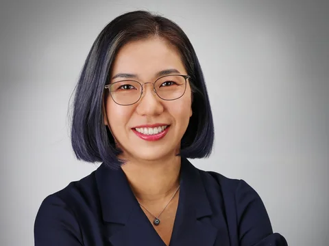 Dr. Sarah Ko headshot, wearing glasses and dark collared shirt.