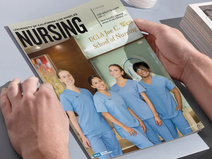 The hands of someone holding the UCLA Nursing magazine issue. 