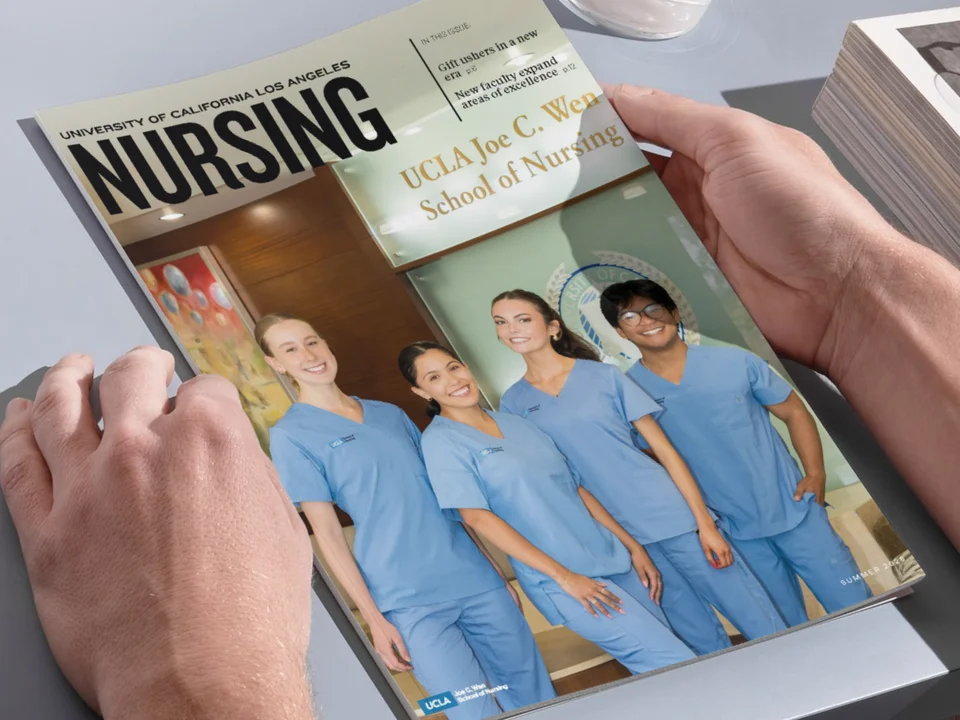 The hands of someone holding the UCLA Nursing magazine issue. 