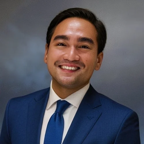Paolo Roca wearing a blue suit.