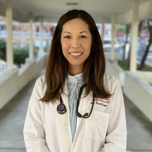 Thao Rodriguez wearing a white coat with a stethoscope around her neck.
