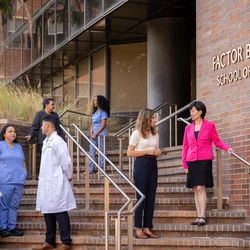 UCLA Nursing Dean Lin Zhan speaking with students in front of the School of Nursing.
