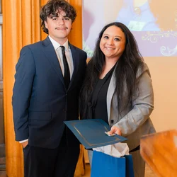 Julie Bernardo pictured with an ASUCLA representative at the True Bruin RAISE Award ceremony.