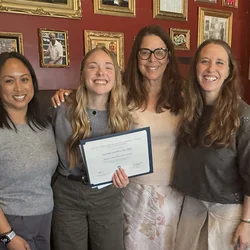 Lexi Phillips holding her scholarship award with 3 nurses from the LA NAPNAP Chapter