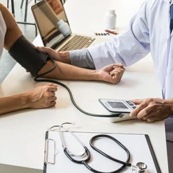 A doctor checking the blood pressure of a patient. 