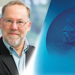 UCLA alumnus Fred Ramsdell pictured next to Nobel Prize imagery