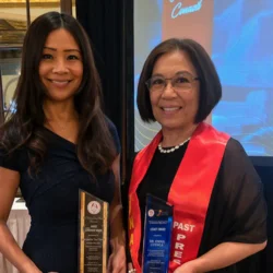 Carol Cunningham and Emma Cuenca holding their awards at the PNASC Award Ceremony. 