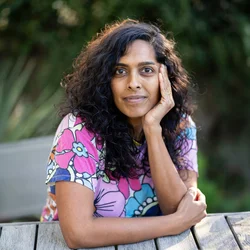 UCLA nursing student Priya Swaminathan sitting at a park bench.