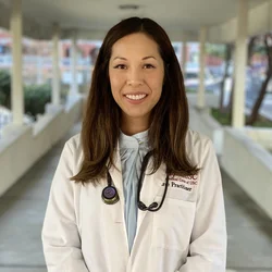 Thao Rodriguez wearing a white coat with a stethoscope around her neck.
