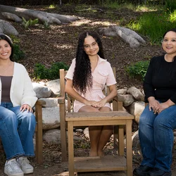 Nursing students Julie Bernardo, Vanessa Martinez, and Danielle Paisley sitting in the UCLA Botanical Garden.