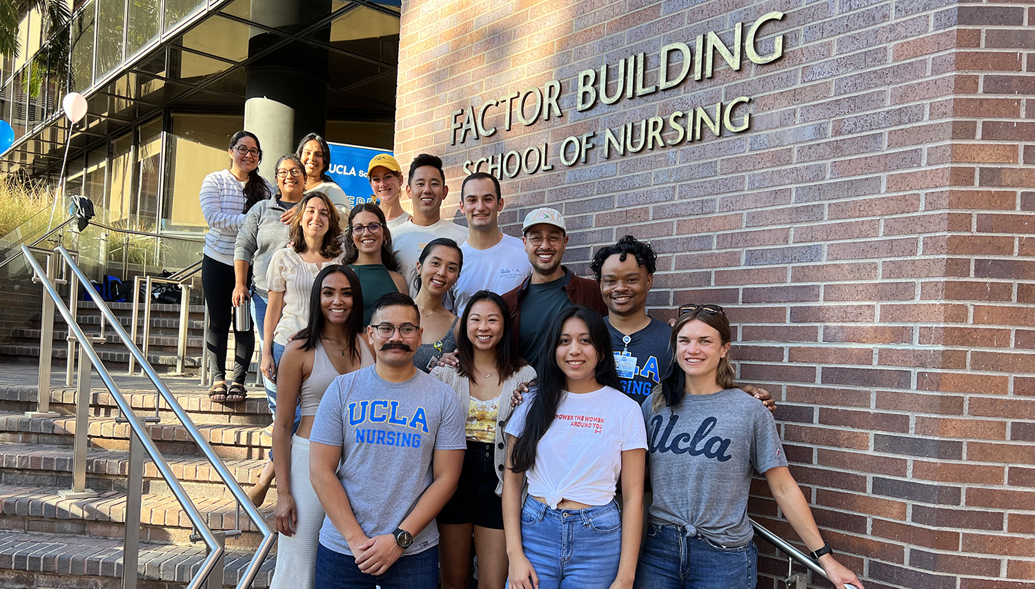 Nursing students standing in front of the UCLA Nursing main entrance