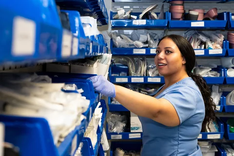 A nursing student getting supplies from the Simulation Lab supply room